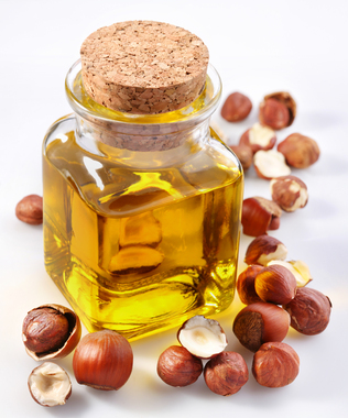 filbert oil with nuts on a white background